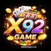 X92 Game logo with glowing golden X, colorful 92, casino icons, poker cards, dice, and coins on black background.